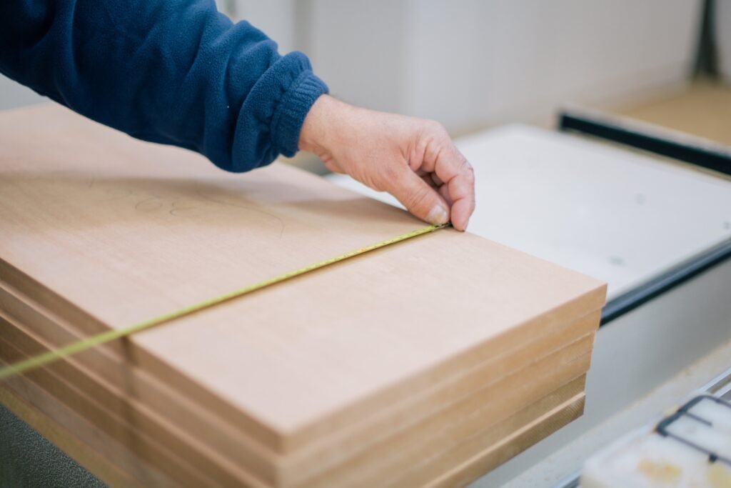 carpenter measuring wood